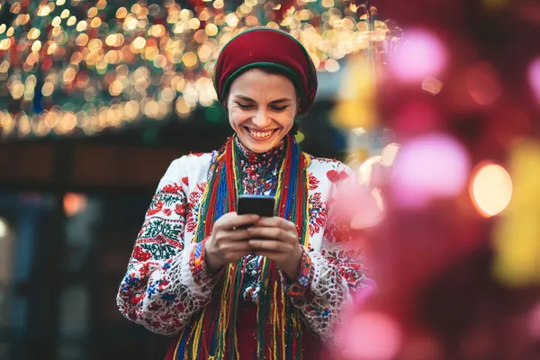 A woman in a luxurious green gown next to an ornate roulette wheel, capturing the upscale casino mood of SPINARA.